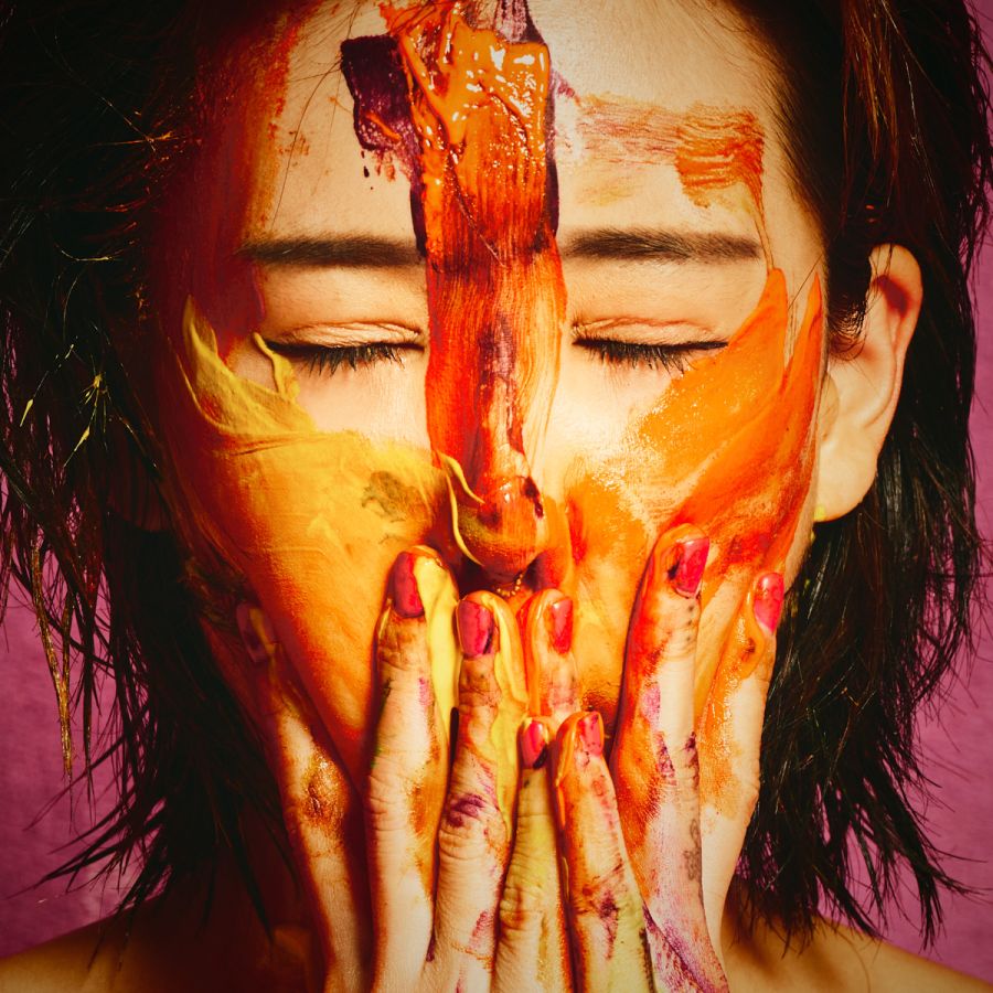 South Korean tattooed model Chloe Painter orange body paint purple fabric backdrop Barcelona photographer Cinaed Dane