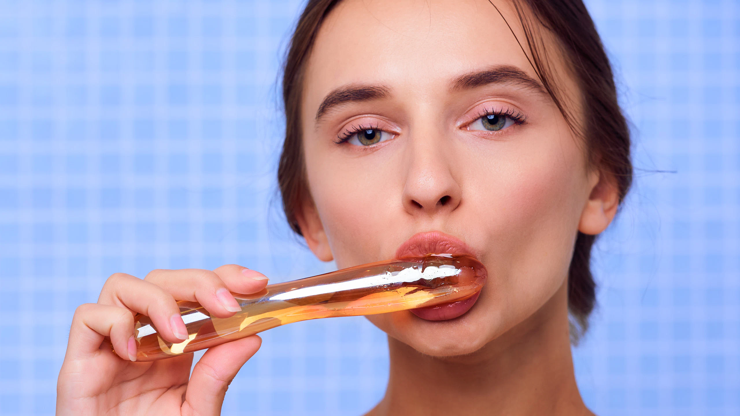 Gloria Sol in the Golden Desires series, honey dripping from glass, sensual portrait