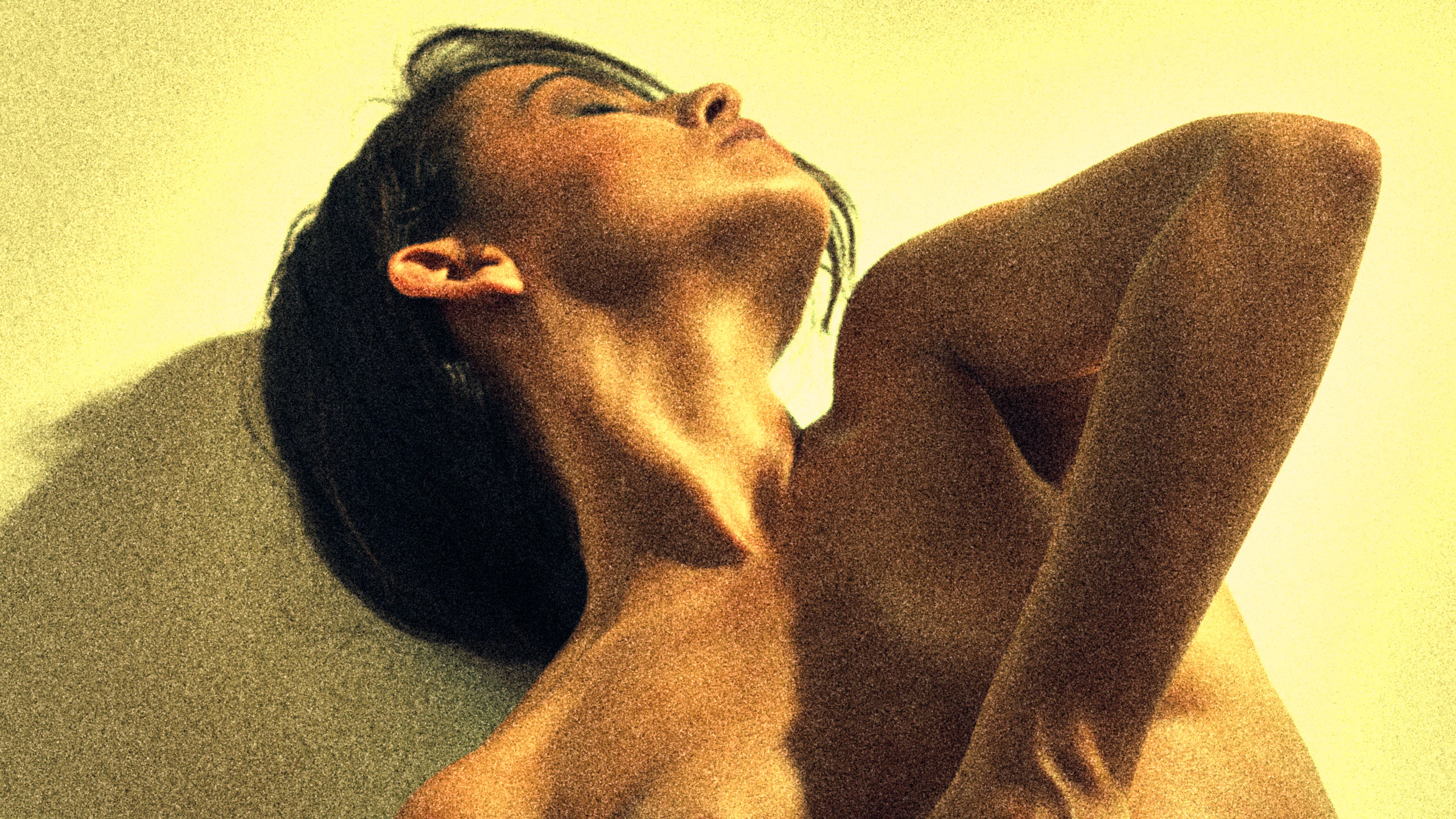 Joy Lamore explicit pose dramatic shadows wall – yellow tone grain edit erotic art photography Cinaed Dane Barcelona