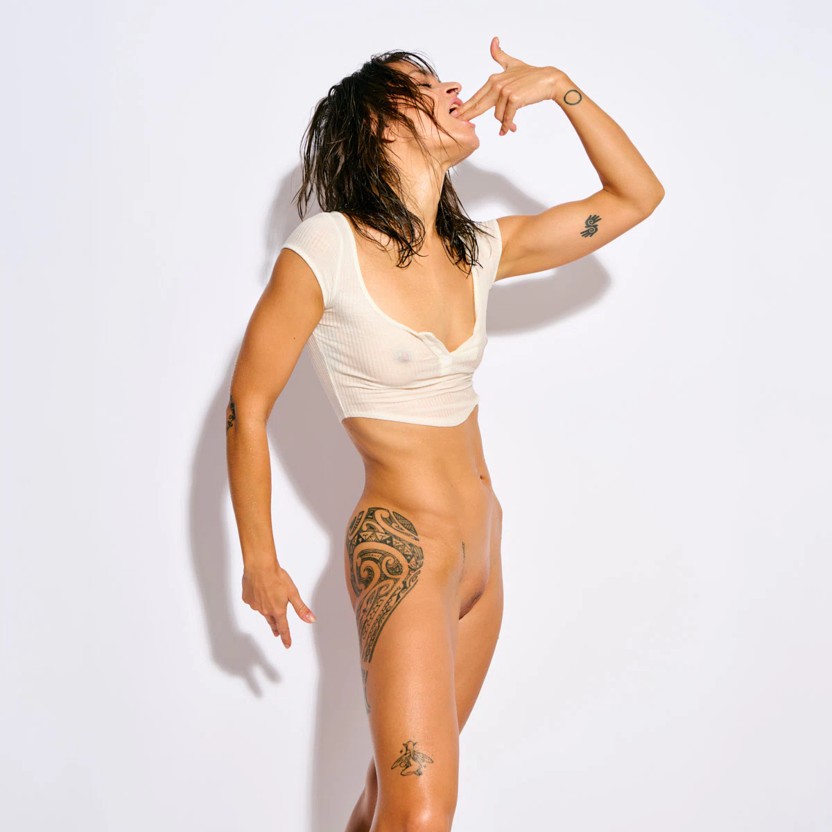 Reb Chi nude in a wet white top with provocative poses and hand gestures.
