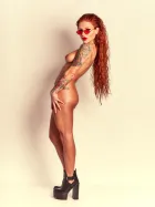 Red Yuliya with long, vibrant red hair in confident, expressive poses from the Red Flame series.