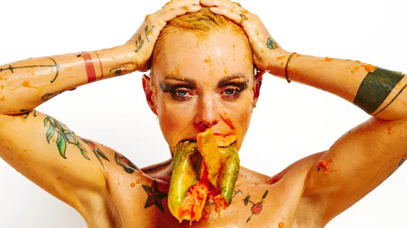 Lu Epic in a fully nude erotic series with papaya fruit smeared on skin and face