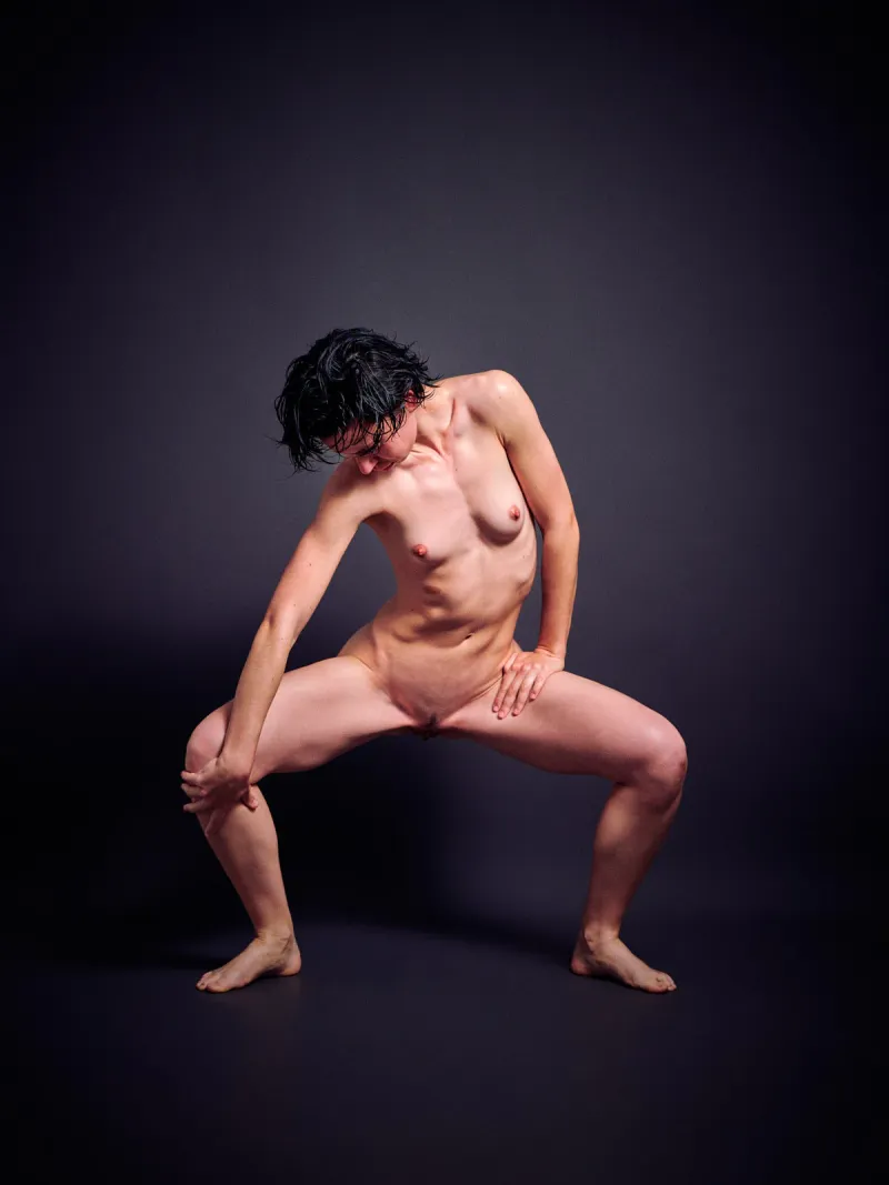 Ulah Bauer nude art model oiled body athletic form dark backdrop photographer Cinaed Dane