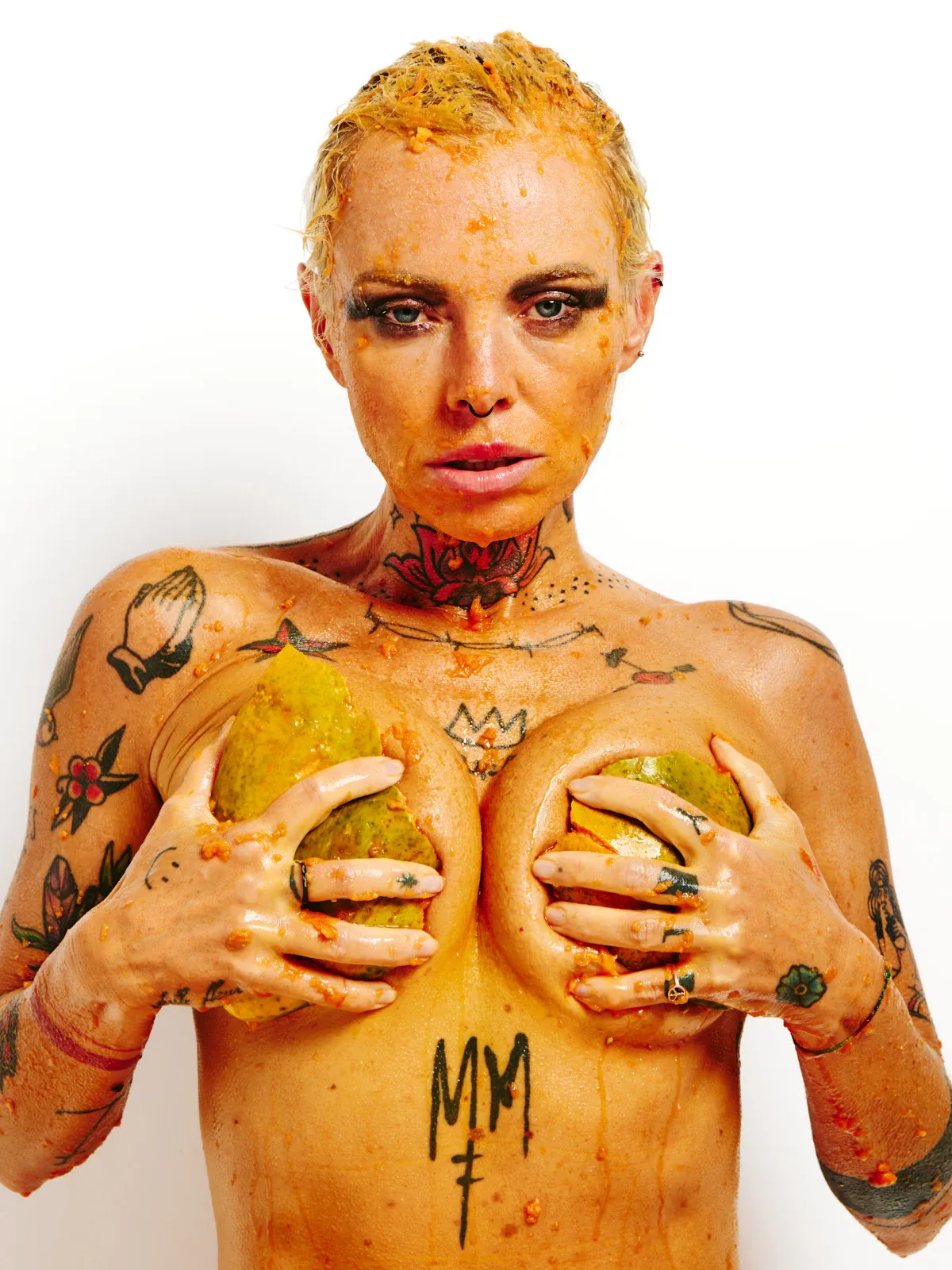 Lu Epic fully nude in an erotic art series eating and smearing papaya fruit across her face and body