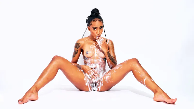 Sensual artistic nude of African Beauty with cream, emphasizing texture and form