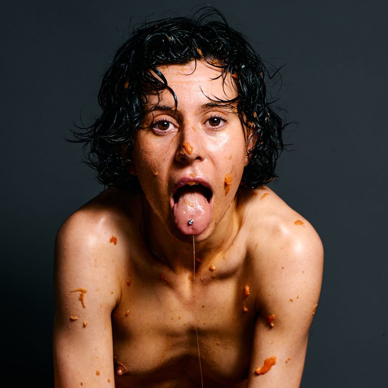 Ulah Bauer nude art model Wet Papaya orange papaya messy sensual expression dark backdrop photographer Cinaed Dane