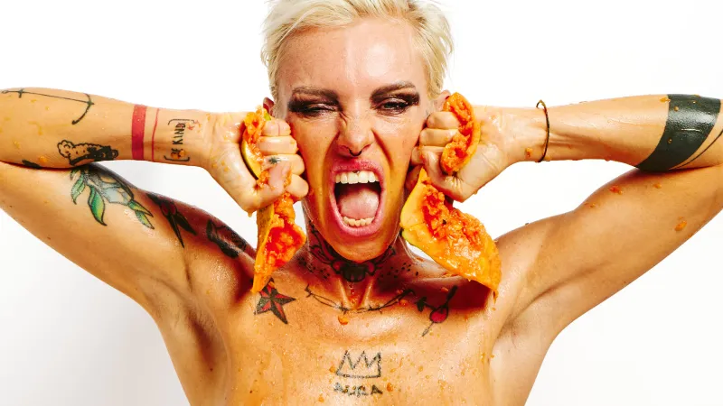 Erotic art portrait of Lu Epic nude with papaya fruit on her body and face