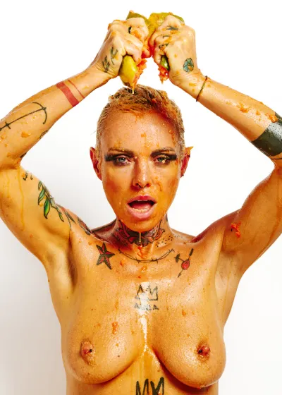 Lu Epic fully nude in an erotic art series eating and smearing papaya fruit across her face and body