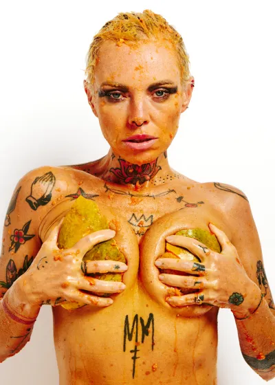 Lu Epic fully nude in an erotic art series eating and smearing papaya fruit across her face and body