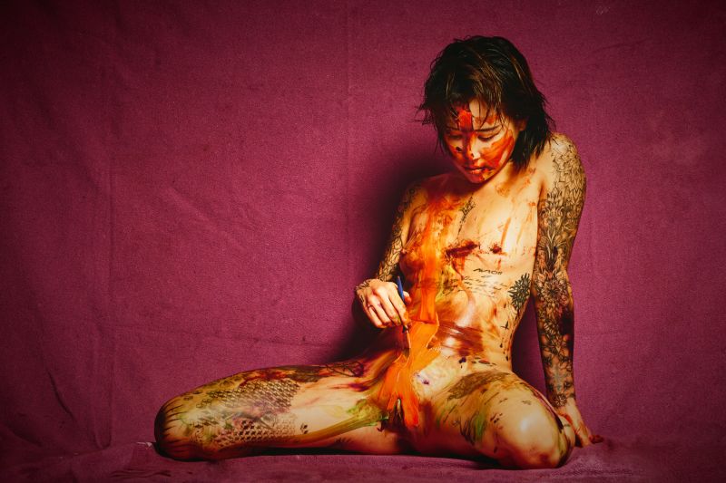 Chloe South Korean nude art model Painter orange paint self-expression purple backdrop photographer Cinaed Dane