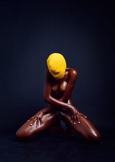 Yellowhead explicit erotic photography anonymous dark-skinned model yellow beanie concealed identity elegant poses contrast restraint visual power by Cinaed Dane