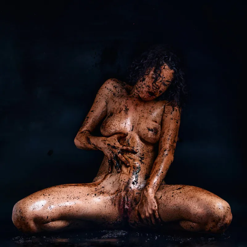Gia Ren covered in dirt, posing provocatively with a messy, earthy aesthetic in the Dirty series, highlighting her body, expression, and tactile textures.